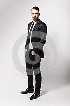Cool young man in dark suit photo