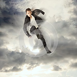 Cool young man jumping and kicking