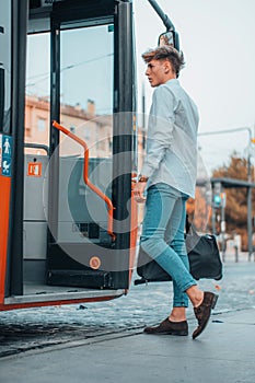 Cool young Spanish male riding up a bus