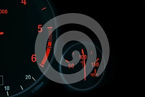 Coolant temperature gauge and tachometer on a car`s dashboard. Modern Car interior details. Close up view