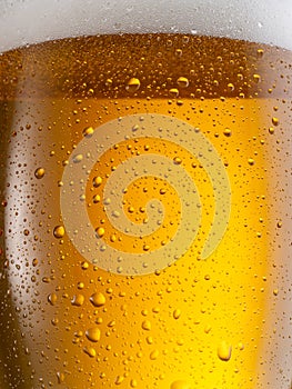 Cooled glass of beer close-up. Small water drops on cold surface of beer glass