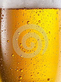 Cooled glass of beer close-up.  Small water drops on cold surface of beer glass