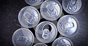 Cooled soda cans ready to drink on black background