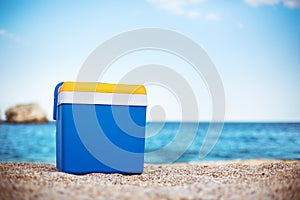 Cooler box on the sand beach photo