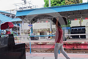 Cooliekoelie, kuli, cooli, cooly-person paid to carry people`s bags at a railway station