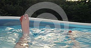 Coolin off in water inflatable pool in summer