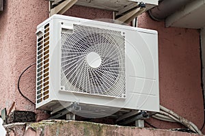 Cooling Fan Air Conditioner on red wall