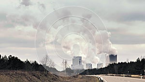 Cooling system of nuclear power plant, huge clouds and smoke in background