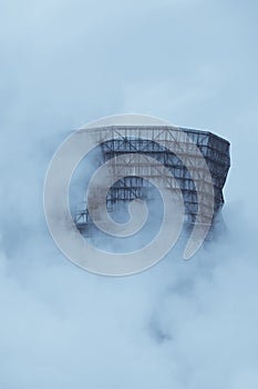 Cooling tower, covered in fog, of a petrochemical plant in Germany monochrome image