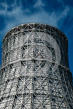 Cooling tower of nuclear power plant against blue sky, close up