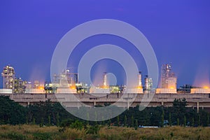 Cooling tower of oil refinery industrial plant at night, Thailand