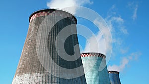 Cooling towers against blue sky in UHD