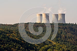 Cooling towers of a nuclear power plant Dukovany over the forest