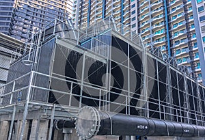 cooling towers with a pipe install on the rooftop of building photo