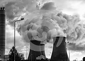 Cooling towers factory industrial spewing pollution and water vapour photo
