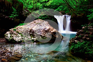 Coolness of a beautiful pool of water created by a waterfall