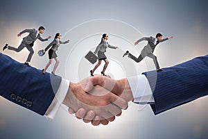 The cooperation concept with people running on handshake