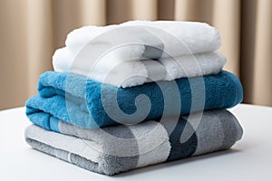 Coordinated comfort Stacked towels in blue, white, and gray showcase elegance