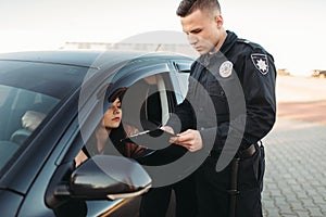 Cop in uniform checks license of female driver