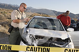 Cop Writing Ticket For An Accident With Man On Call
