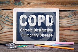 Copd, Chronic obstructive pulmonary disease. Chalkboard on a wooden background