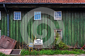 Abandones tagline Votes for Women, and wheelbarrow for worker in Christiania Freetown with wooden houses photo