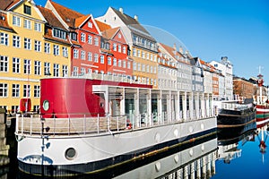 Nyhavn pier with buildings, ships, yachts and other boats in the Old Town of Copenhagen, Denmark