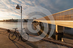 Copenhagen frozen canal at winter and black bicycle near shore - Inderhavnsbroen