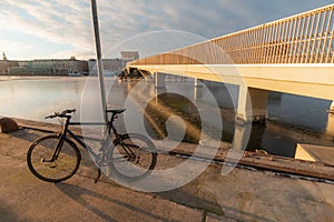 Copenhagen frozen canal at winter and black bicycle near shore - Inderhavnsbroen