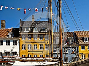 Copenhagen, Nyhavn, antique houses with bright colorful facades and old ships moored