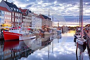 Copenhagen. Nyhavn Canal, colorful houses and city embankment at sunrise.