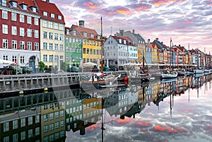 Copenhagen. Nyhavn Canal, colorful houses and city embankment at sunrise.