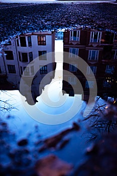 Copenhagen reflected in a water puddle