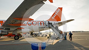 Passengers of EasyJet airline enter the airplane