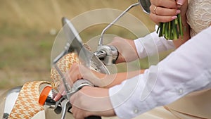 Cople driving together a scooter, wedding