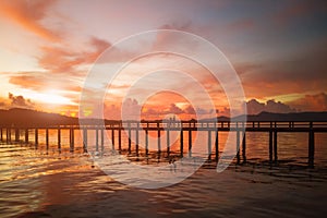 Cople walking on look sunset wooden bridge