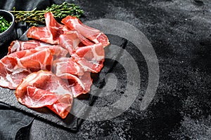 Coppa, Capocollo, Capicollo meat popular italian antipasto food. Black background. Top view. Copy space