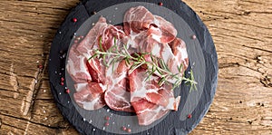 Coppa di Parma ham on slate board with rosemary salt and pepper