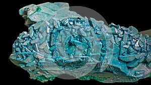 copper ammonium carbonate. blue crystals on a black background