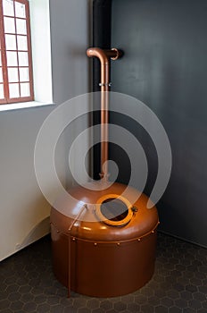 Copper brewing tank with wort in old brewhouse