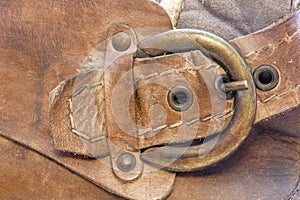 Copper clasp on a brown leather boot