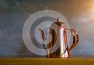 Copper coffee pots on wood shelf for home interior