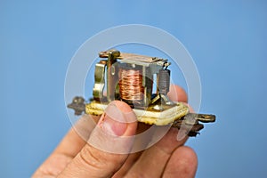 Copper coil switch in the hands of a master