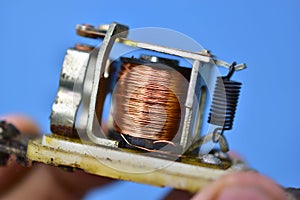 Copper coil switch in the hands of a master