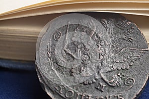 Copper coins of 1785 in Russia with the arms close-up under the book pages