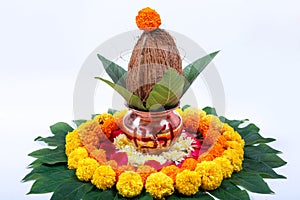 Copper Kalash with coconut , leaf and floral decoration on a white background. essential in hindu puja.