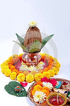 Copper Kalash with coconut , leaf and floral decoration on a white background. essential in hindu puja.