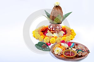 Copper Kalash with coconut , leaf and floral decoration on a white background. essential in hindu puja.