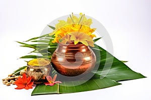 Copper kalash with coconut mango leaf and marigold flower isolated on white background for traditional rituals and ceremonies,