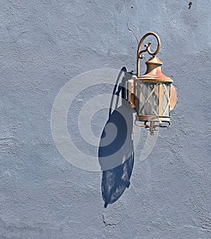 Copper Lantern Against Stucco Background